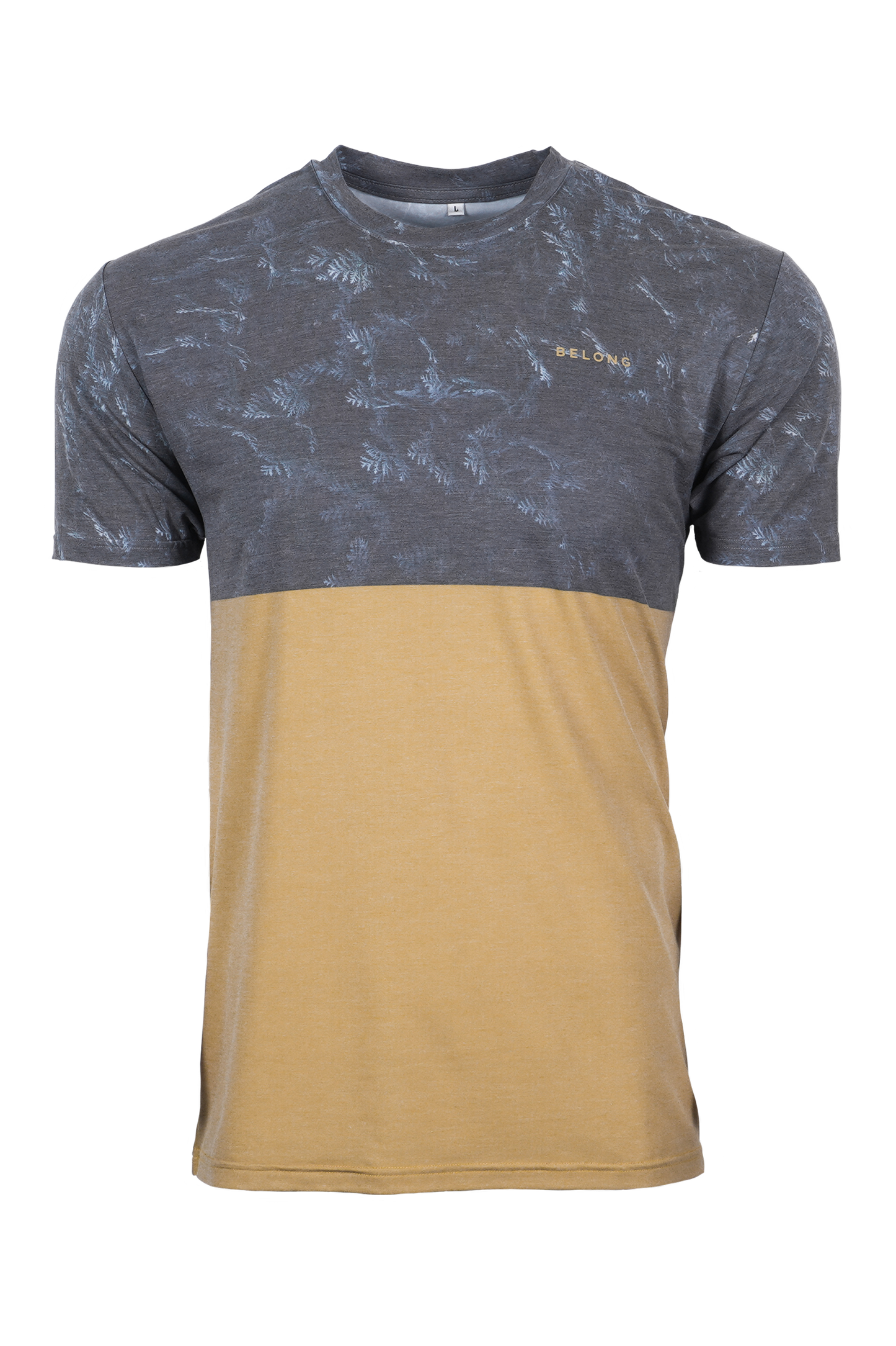 A man stands against a plain background, smiling. He wears a blue and orange camo-patterned Traverse Tek Tee from Belong Designs, made from Recycled VersaTek™ and REPREVE® polyester, black shorts, and brown shoes. He also has a light brown cap. His arms hang relaxed by his sides.